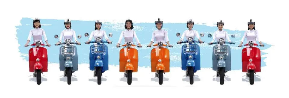 A line of XO guides in white ao dai on pastel-coloured Vespa scooters